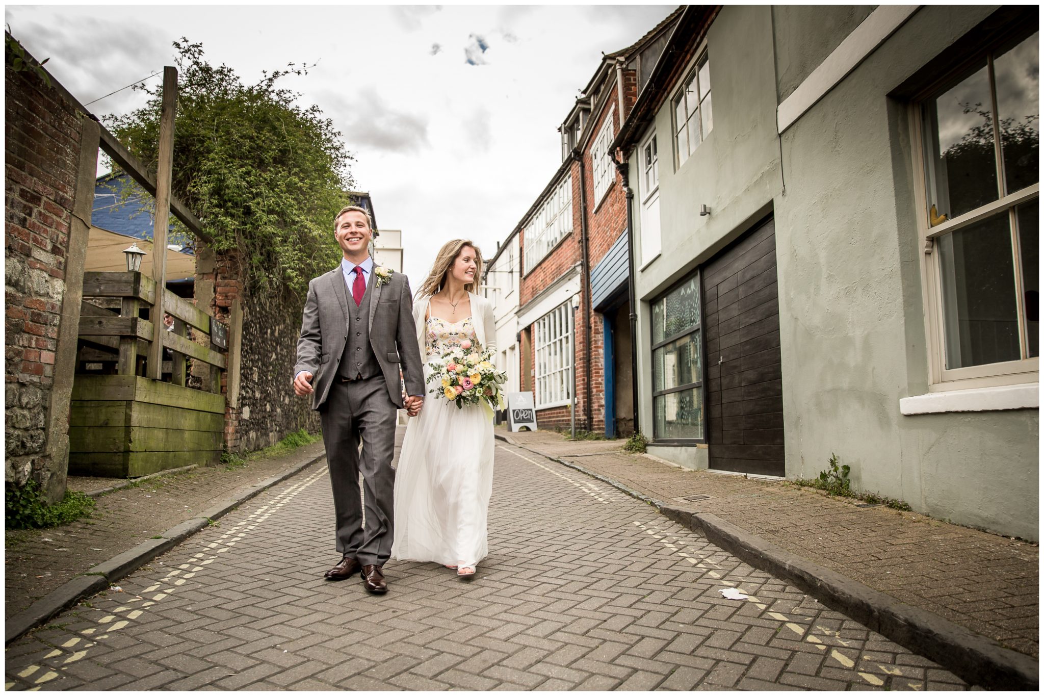 Bride and groom walking through Winchester streets