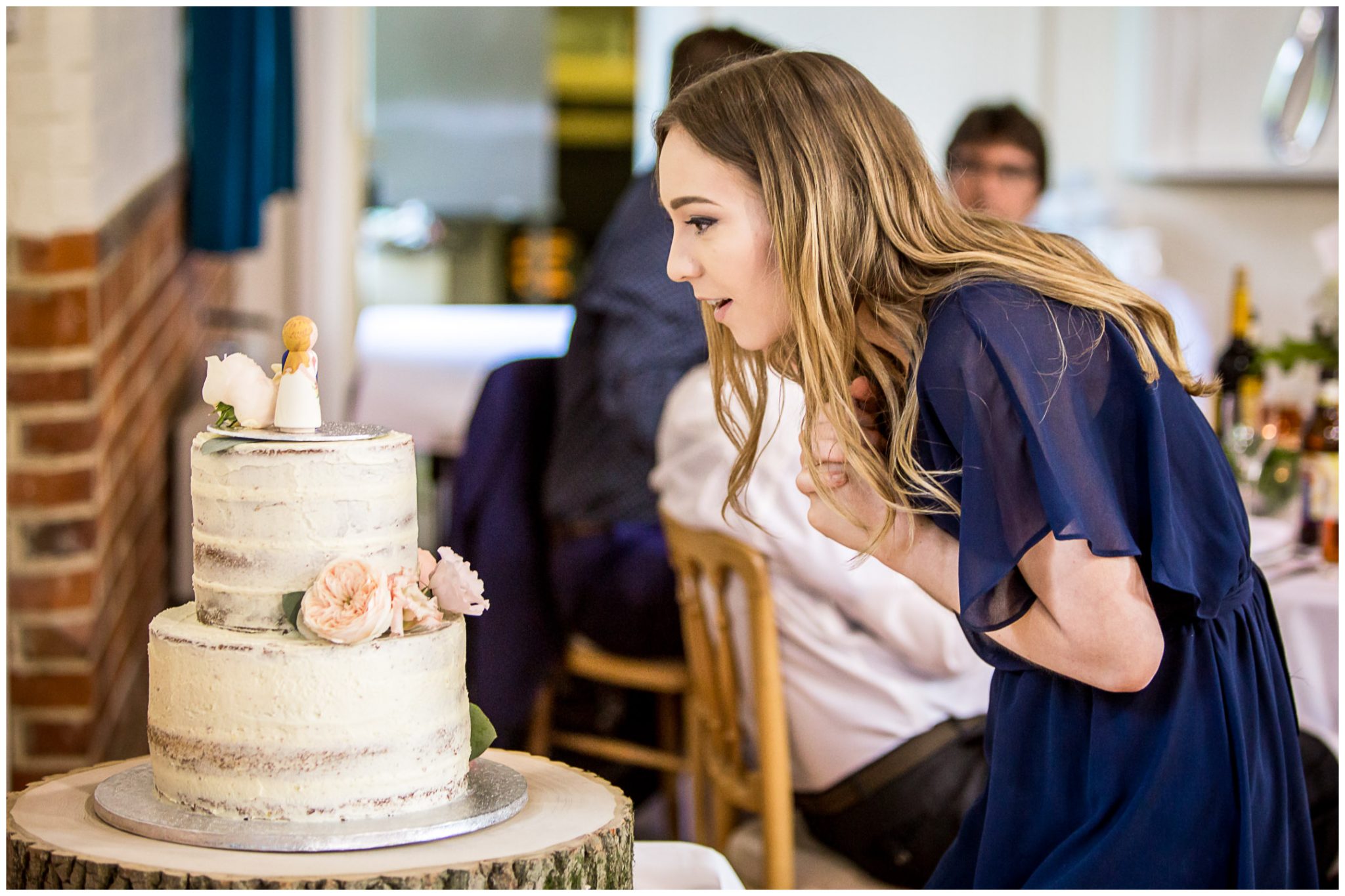 A wedding guest looks at the cake