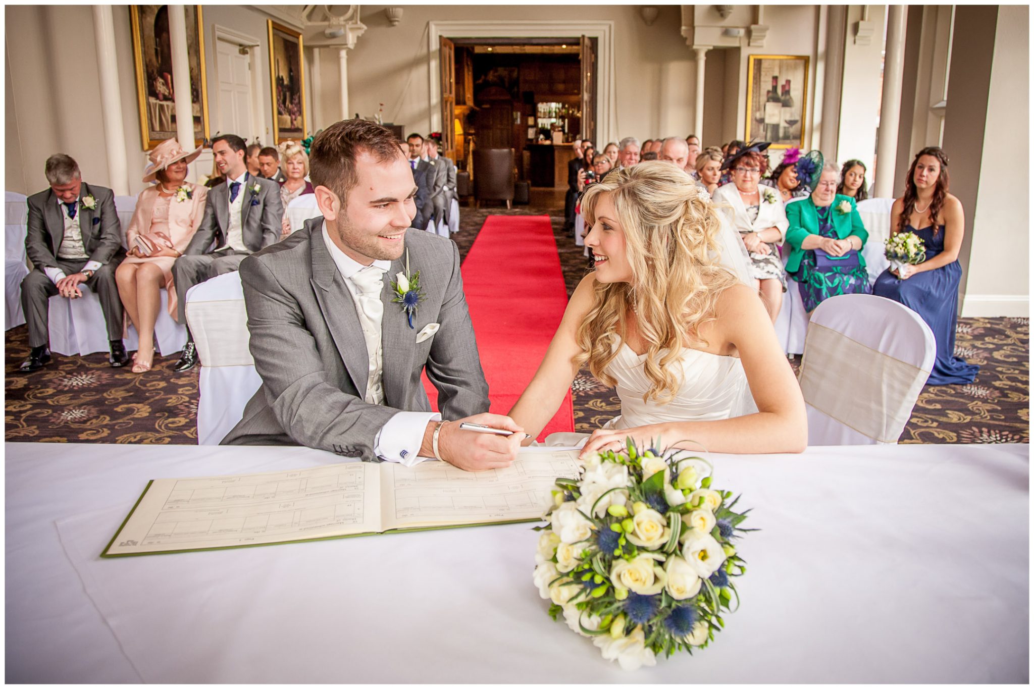 Audleys Wood wedding photography signing the register in the cermony room