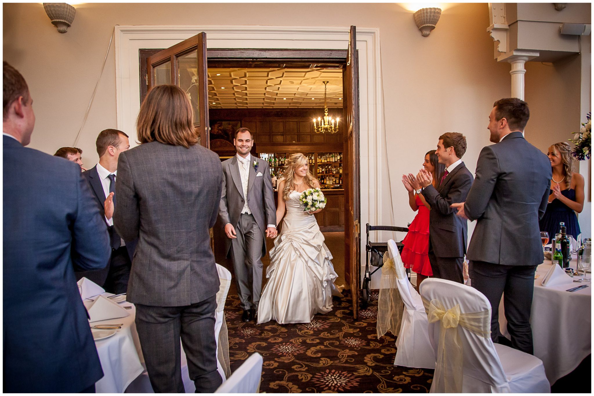 Audleys Wood wedding photography couple enter dining room for wedding breakfast