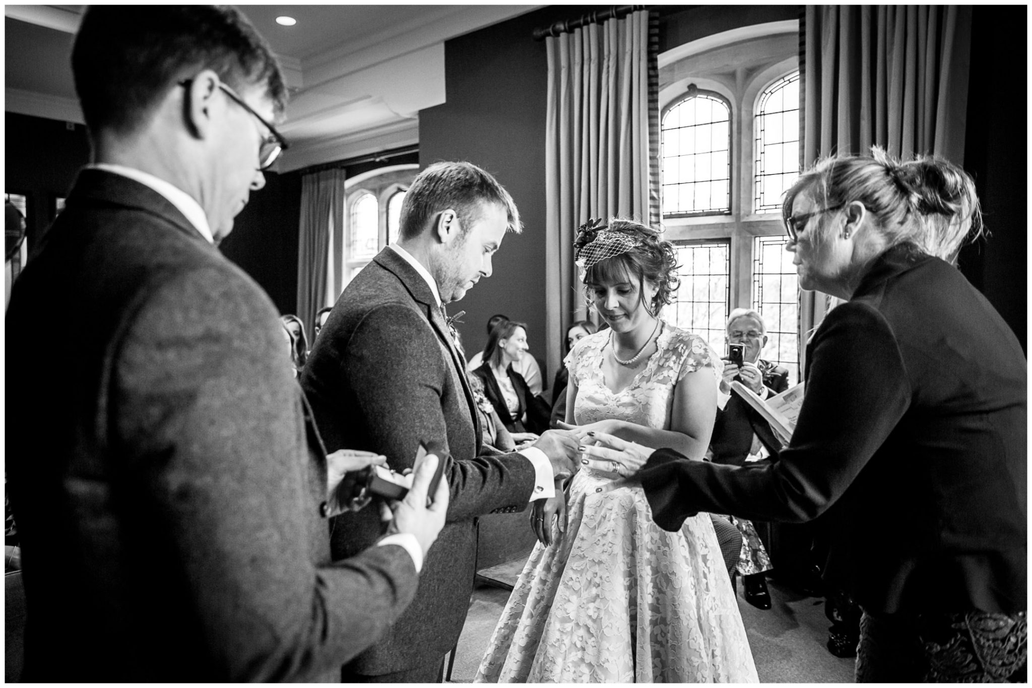Castle Room Winchester wedding photography groom puts ring on finger