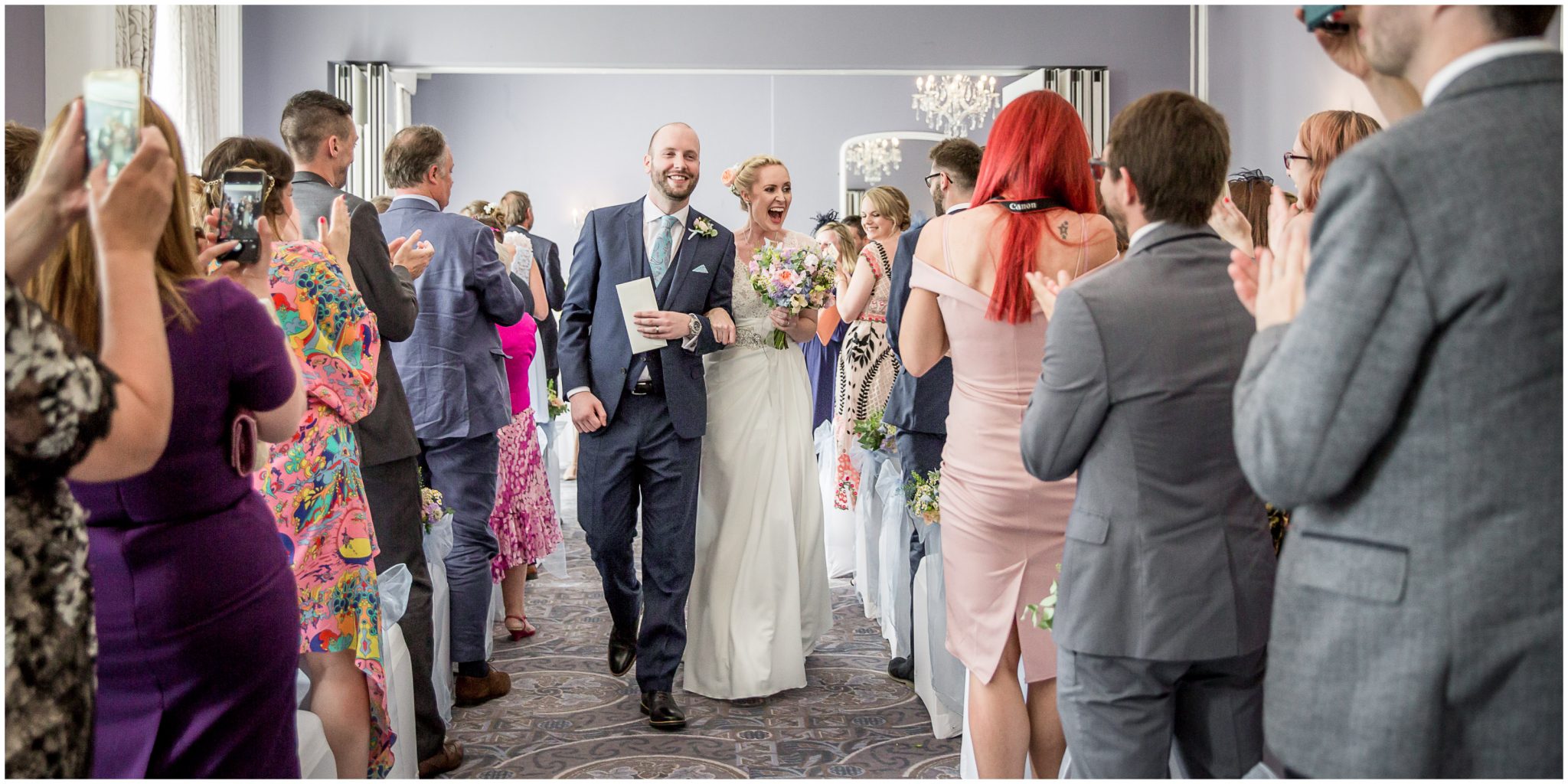 Oakley Hall wedding photography bride and groom walk down aisle