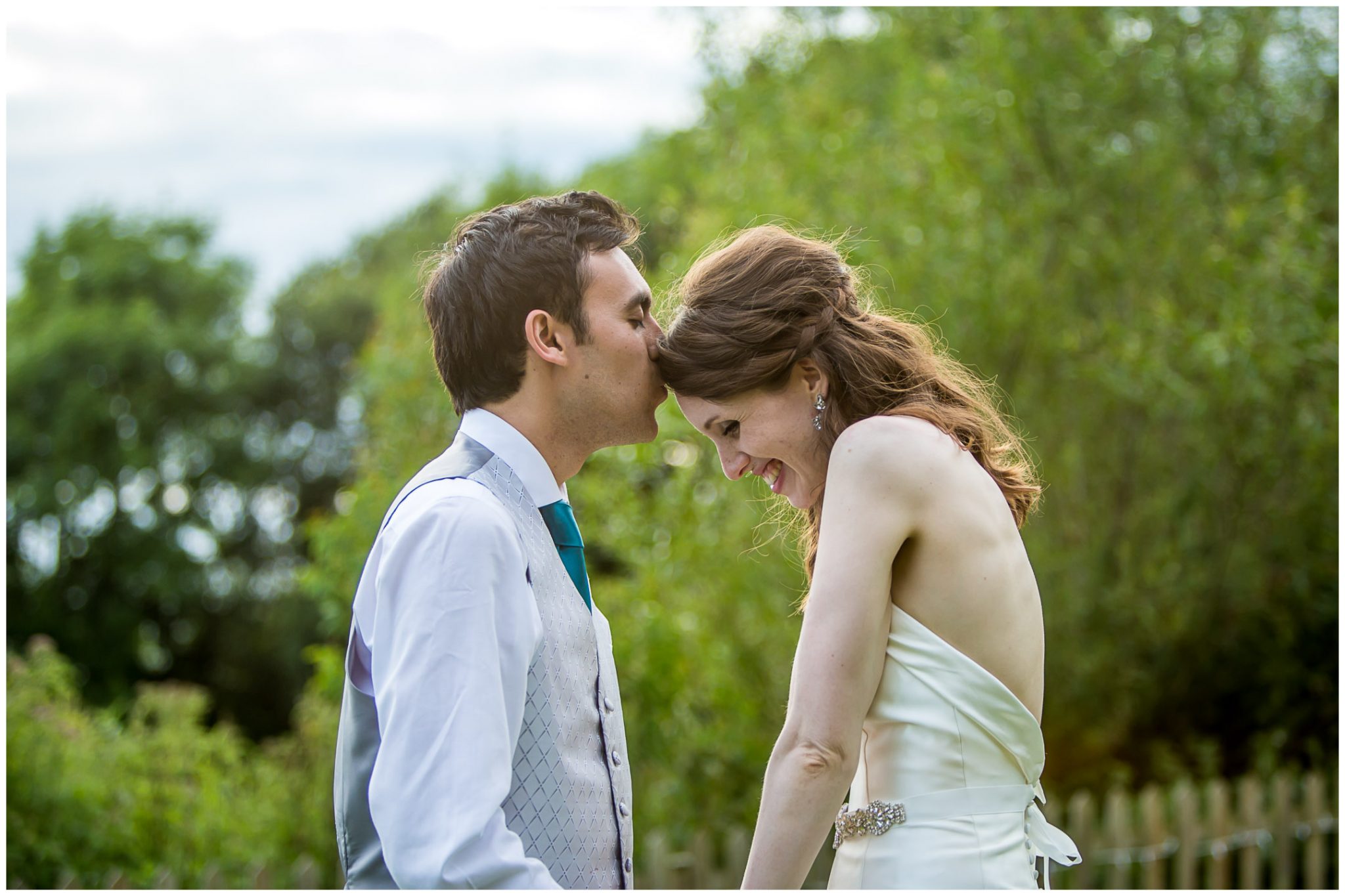 Sopley Mill Summer wedding groom kisses bride on forehead