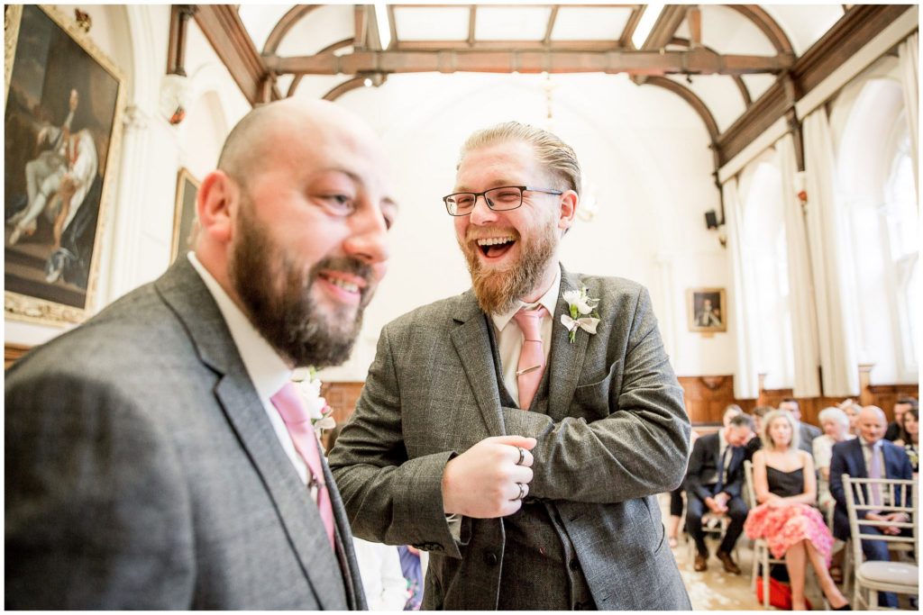 Groom and best man laughing