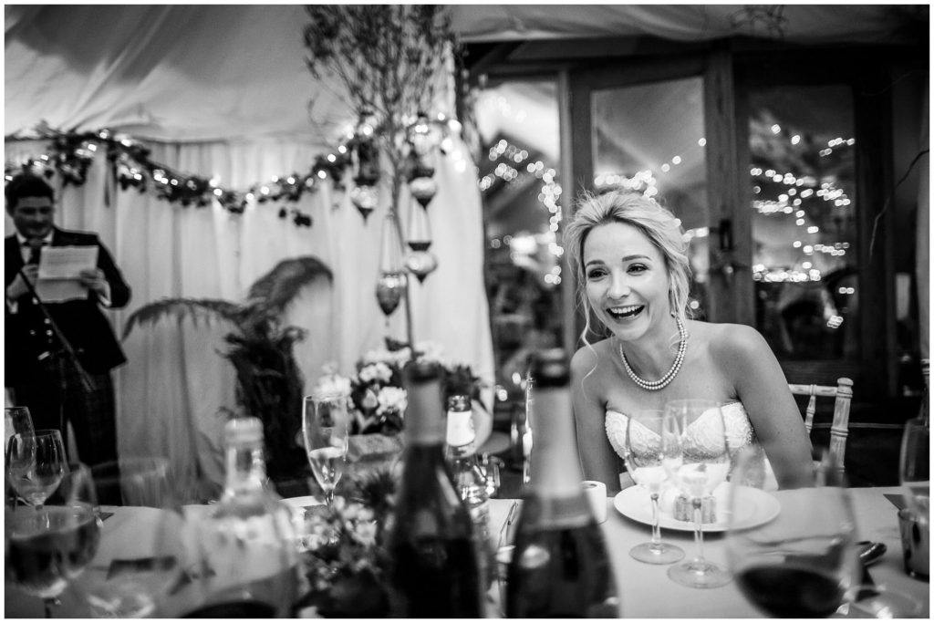 The bride laughing during the speeches