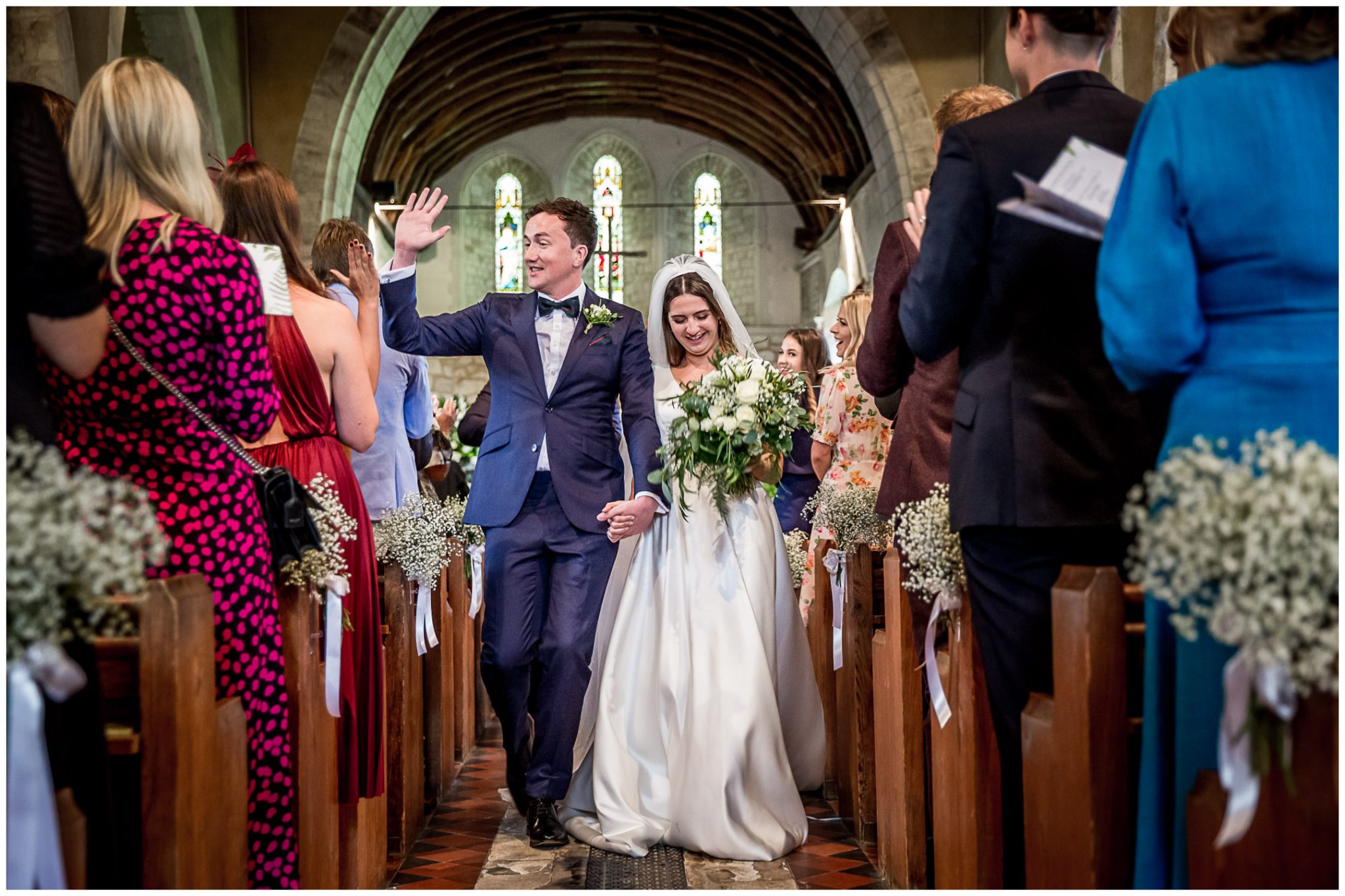 Bride and groom walk down the aisle as husband and wife