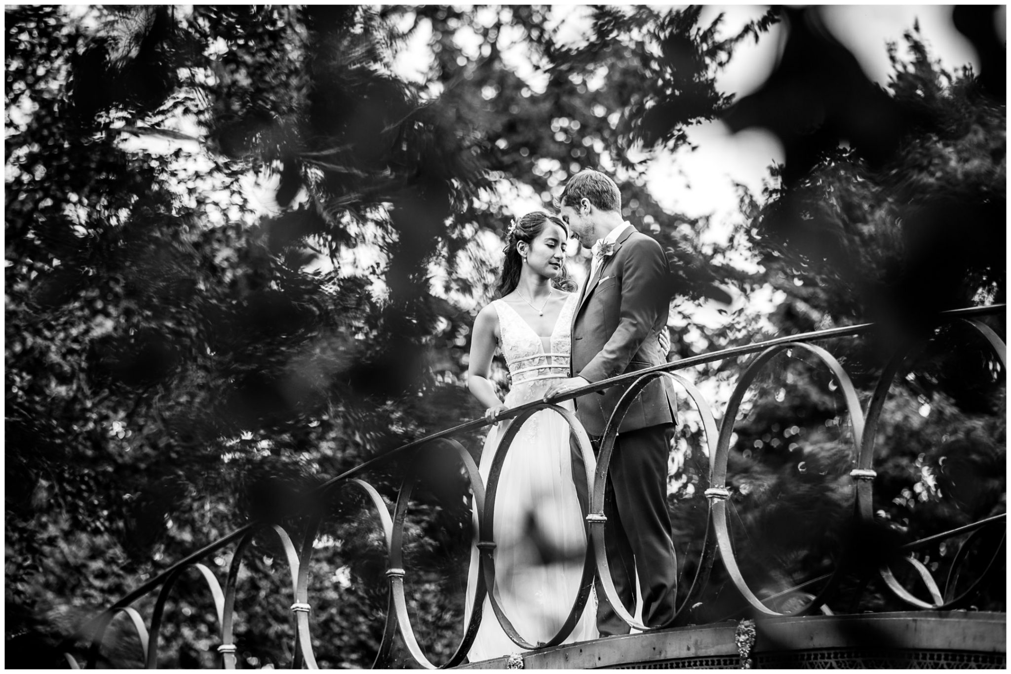Black and white bride and groom portrait on bridge at Avington Park