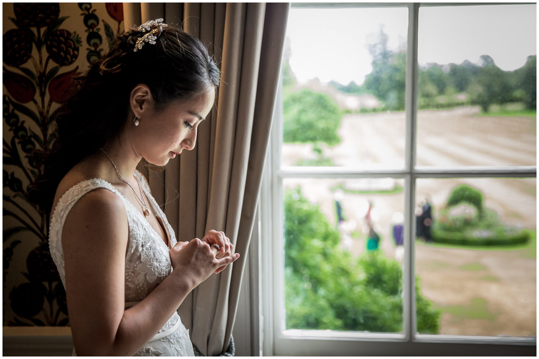 The bride takes a quiet moment for reflection as guests arrive outside