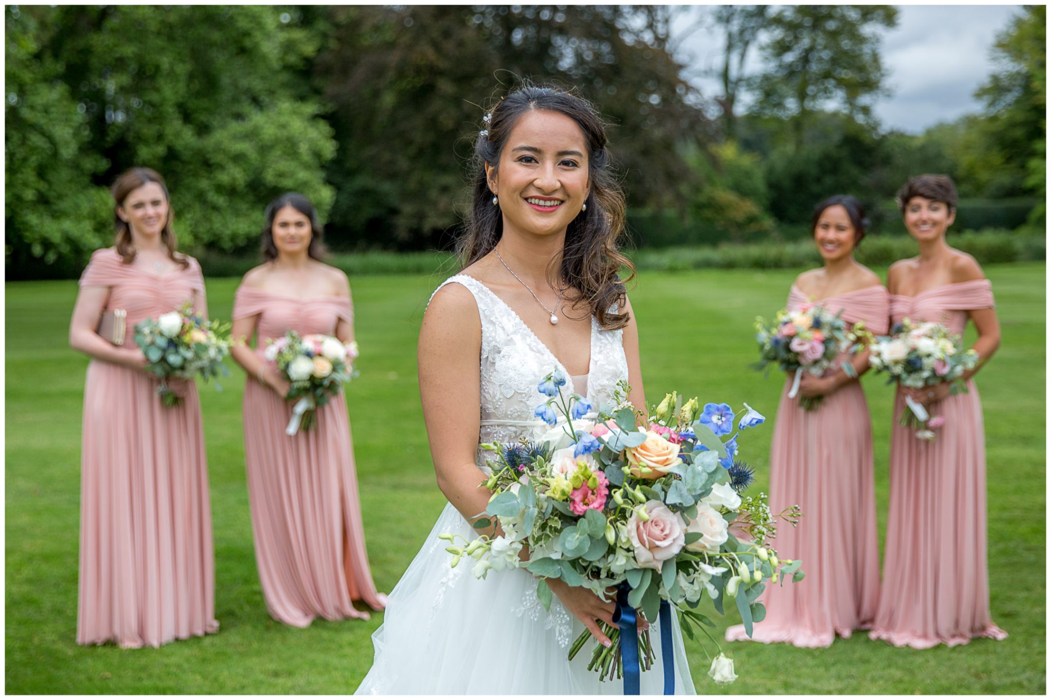 Bride portrait with bridesmaids in the background
