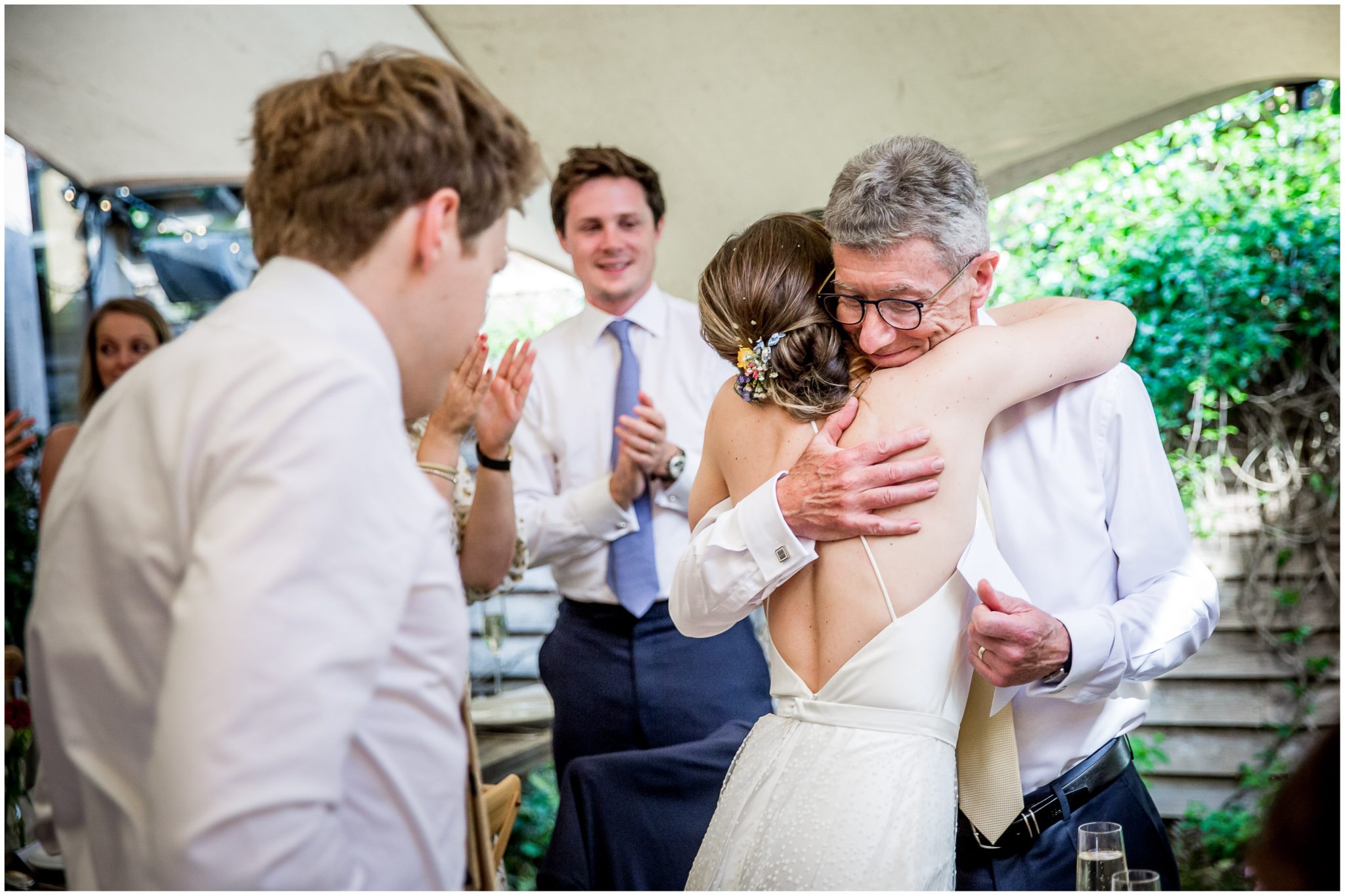 Bride hugs her father after his wedding speech