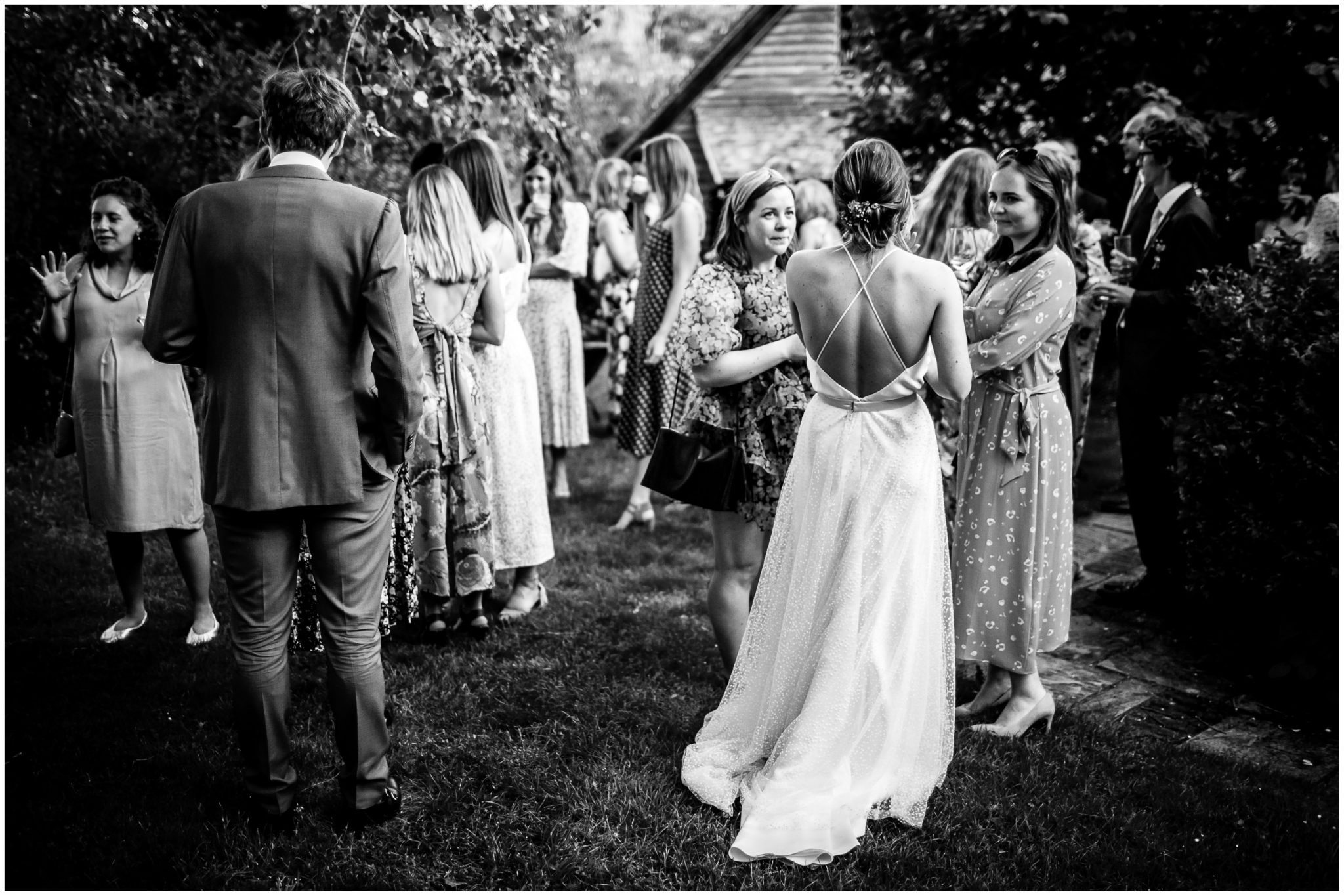 Black and white photo of back of bride's wedding dress