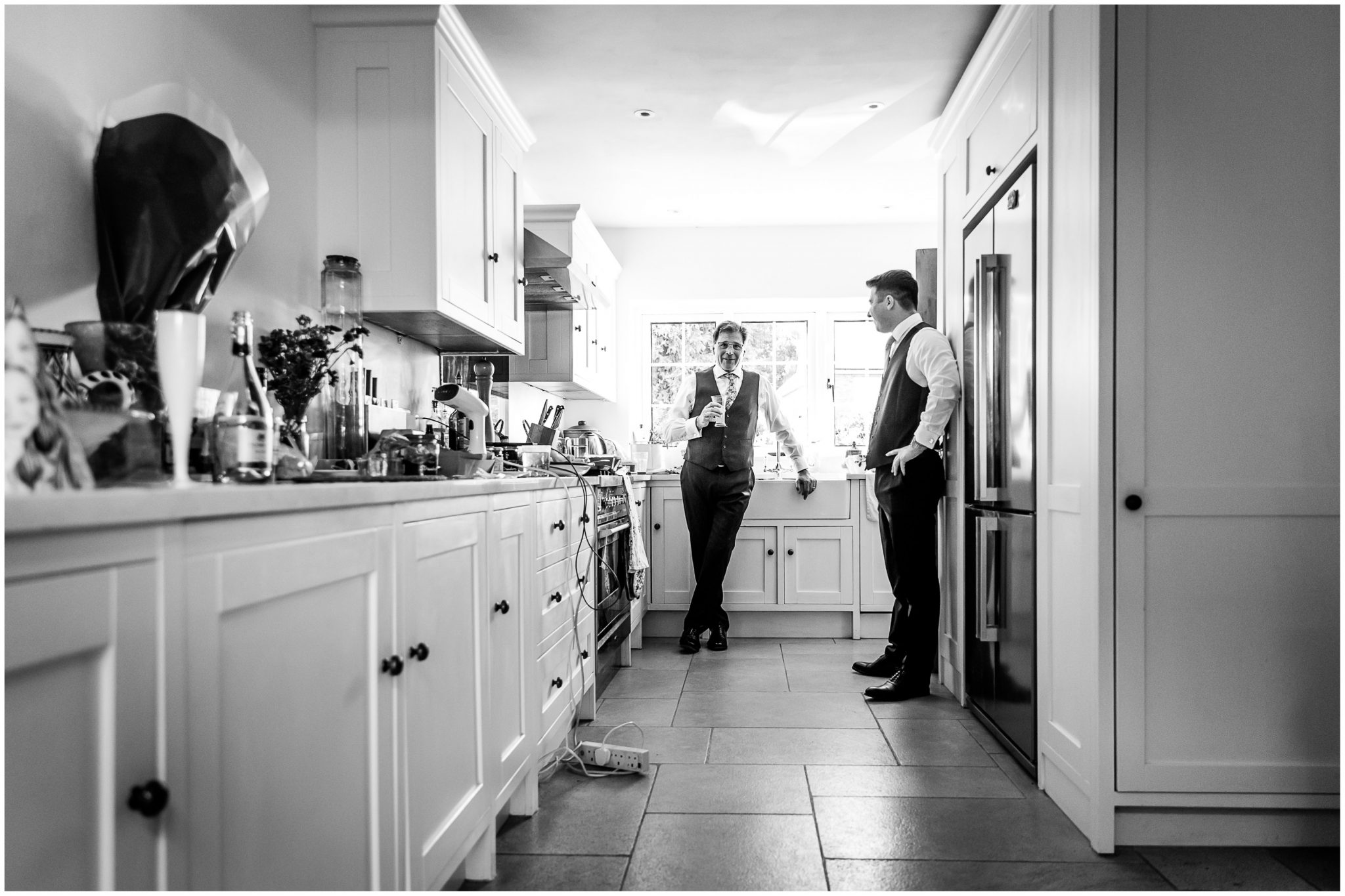 Father and brother of the bride hanging out in the kitchen during the bridal preparations