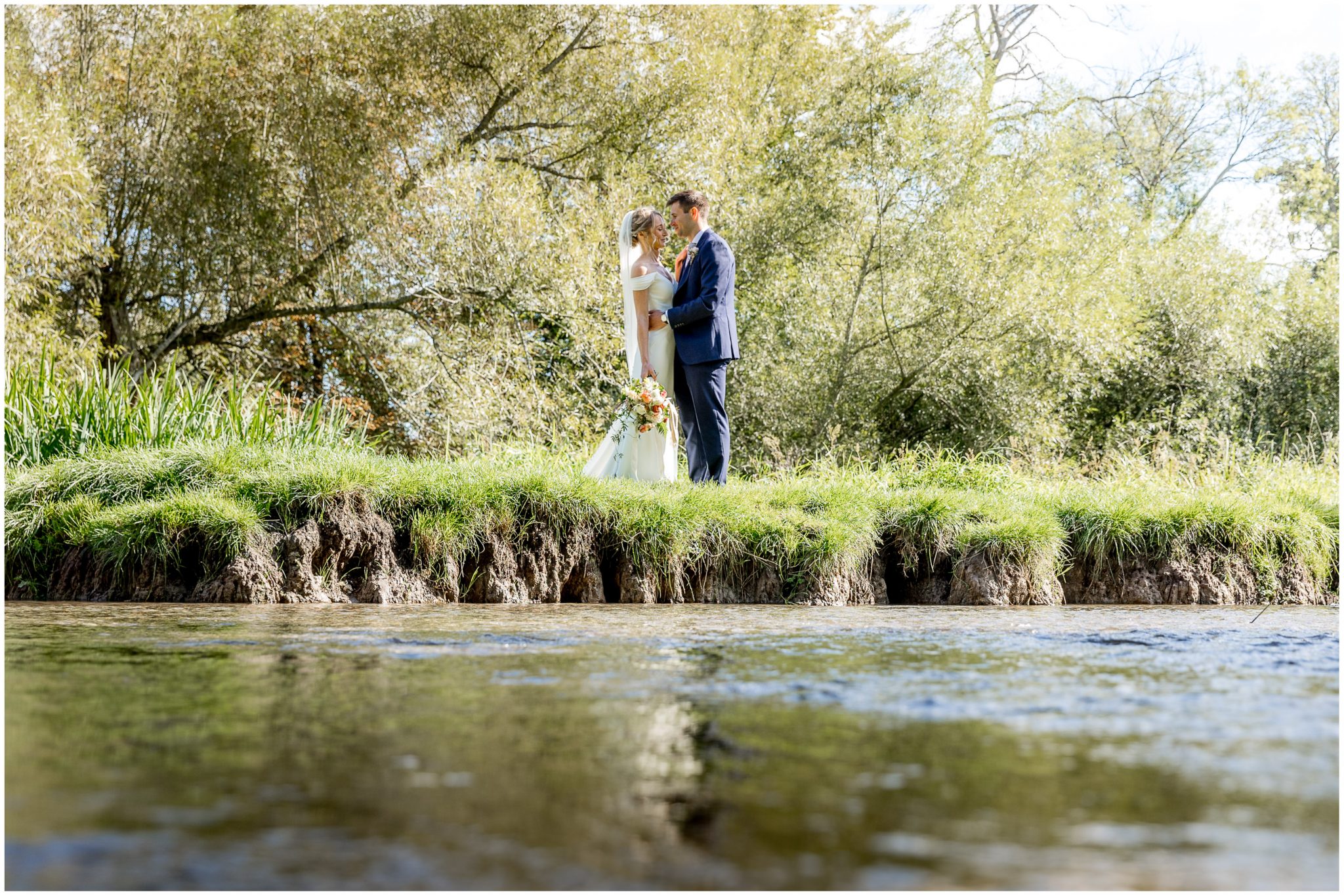 Couple portrait photographs by the banks of the river in Droxford