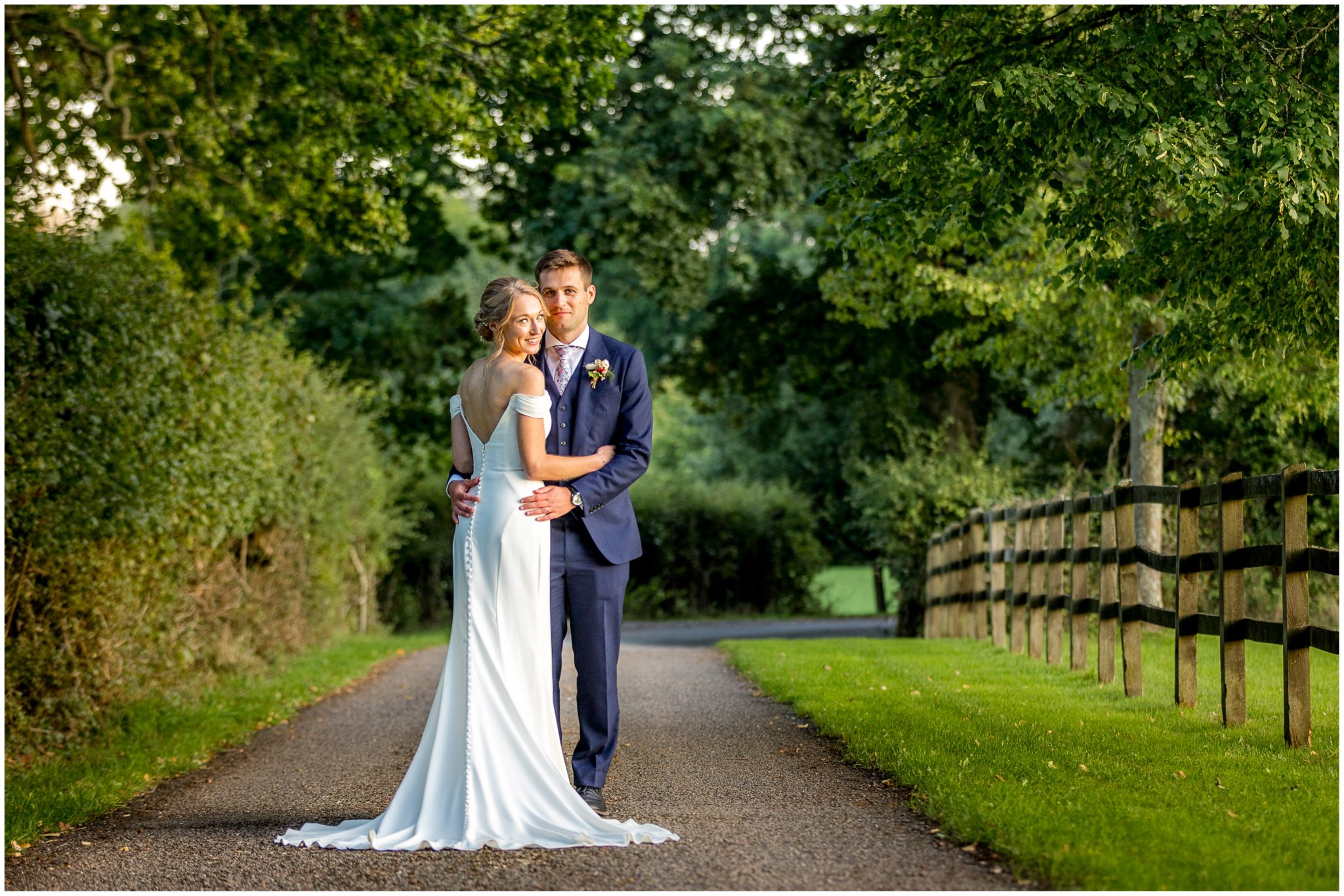 Bride and groom colour portrait in the grounds of Holywell Estate wedding venue