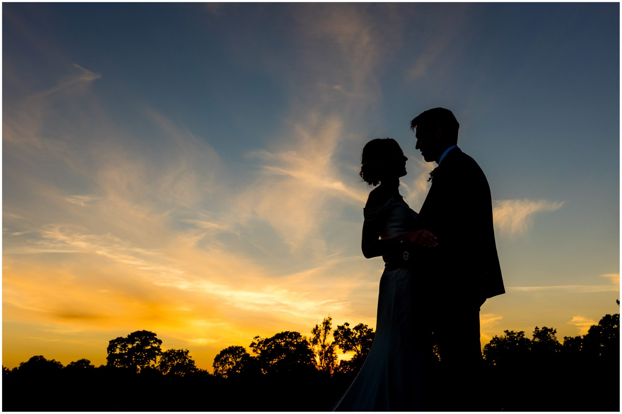 Couple silhouette portrait at Sunset in the grounds of Holywell Estate Hampshire wedding venue
