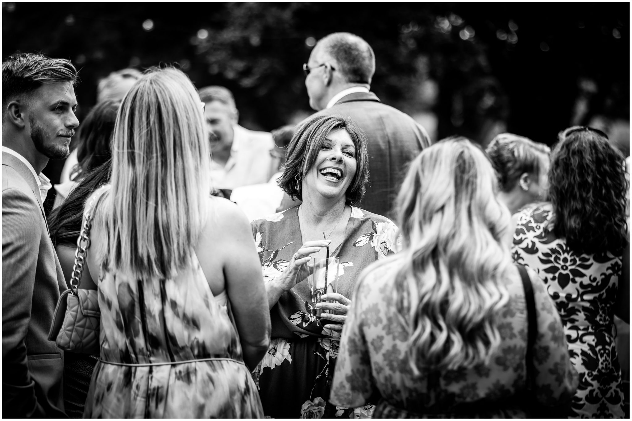 Documentary black and white photograph of guest enjoying the wedding reception