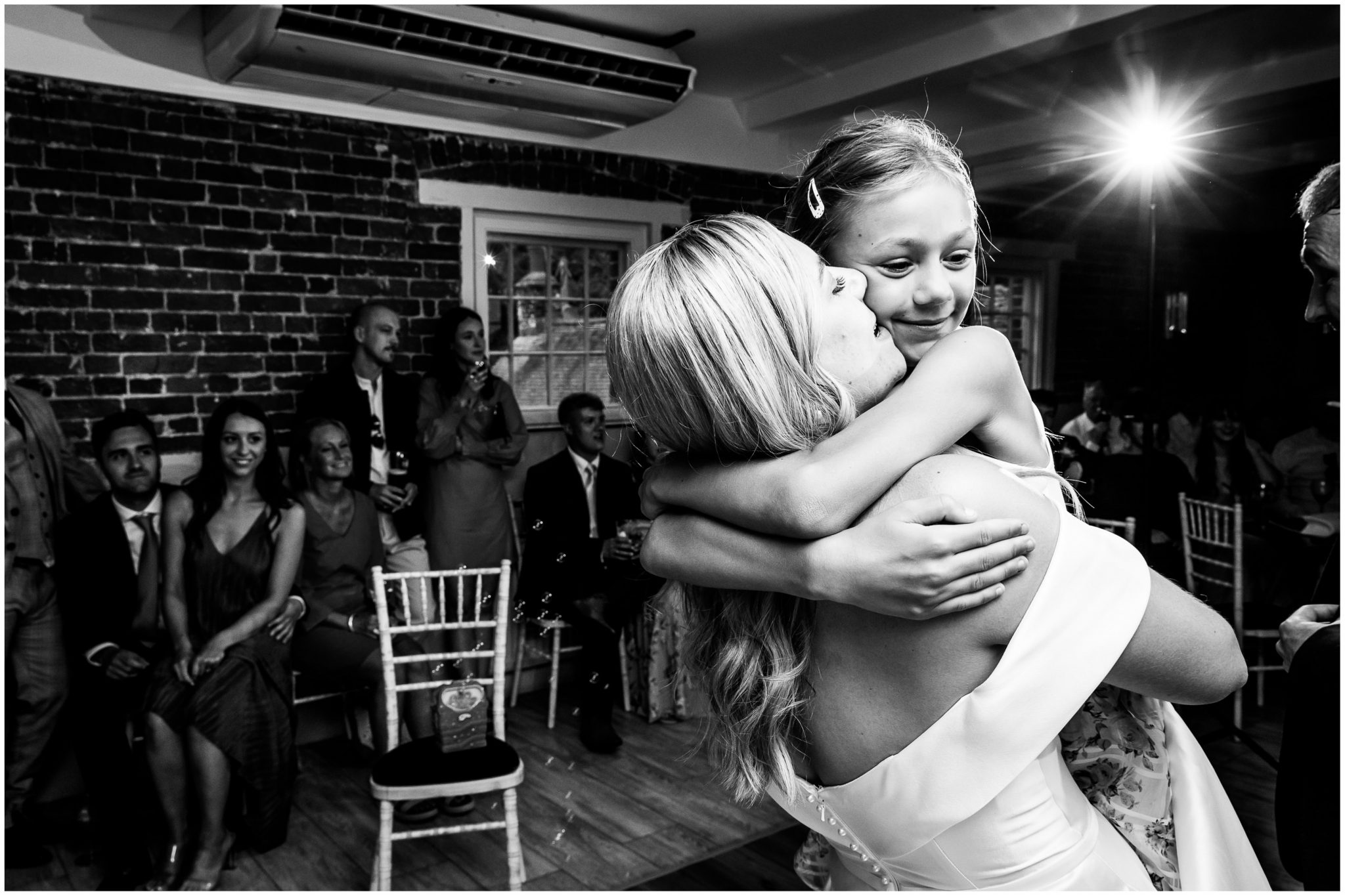 The bride on the dancefloor with a young guest