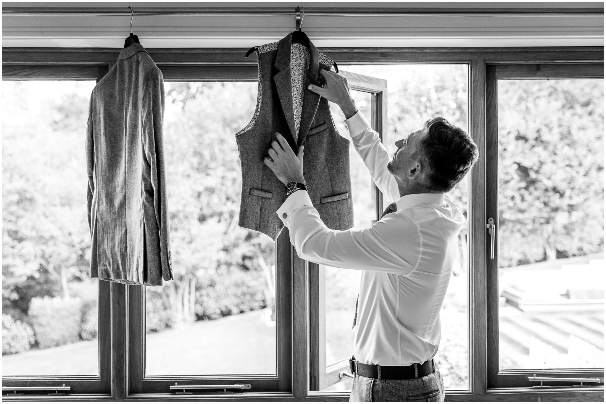 The groom reaches for his waistcoat