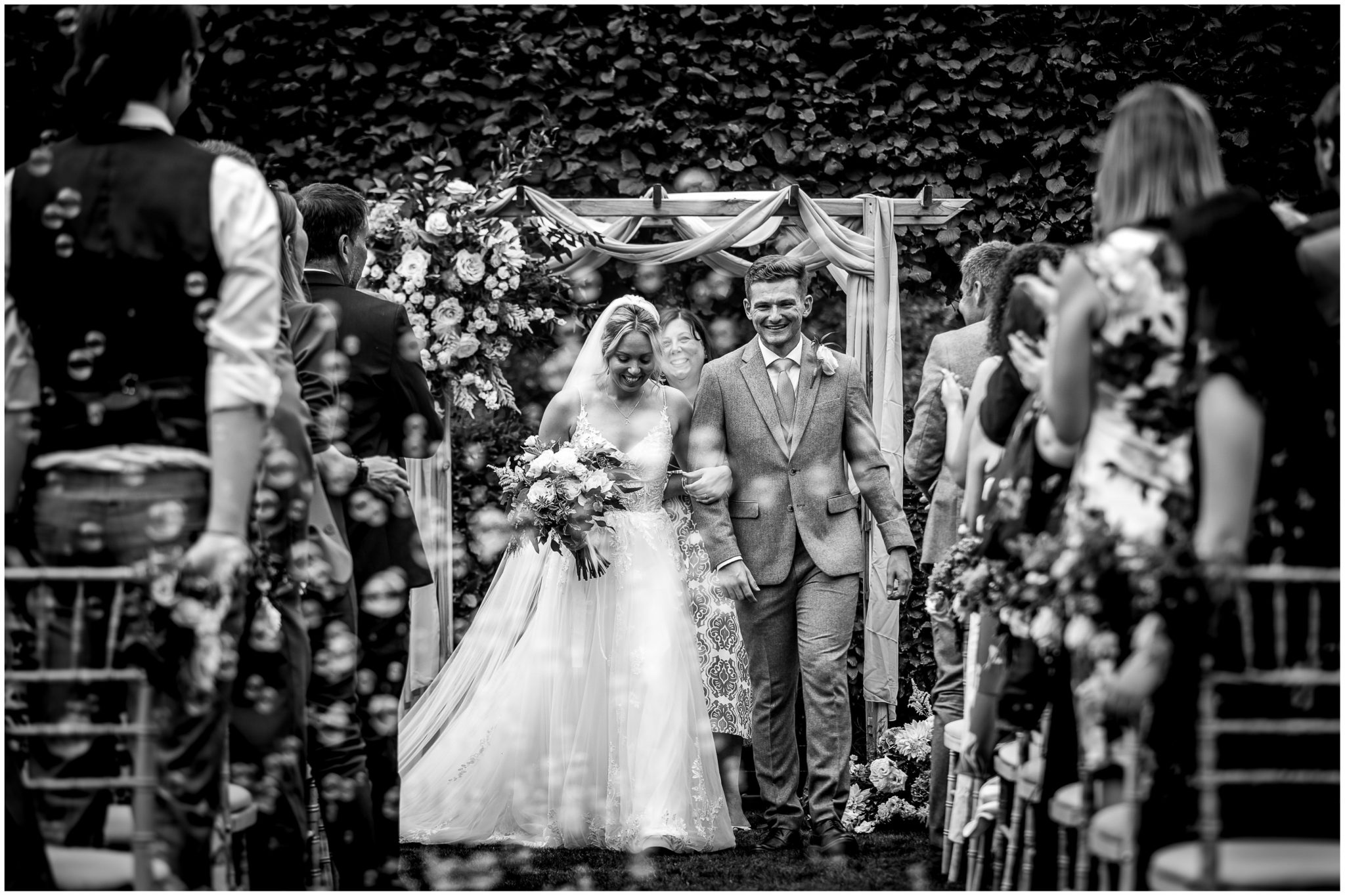 Bride and groom walk back down the aisle as husband and wife