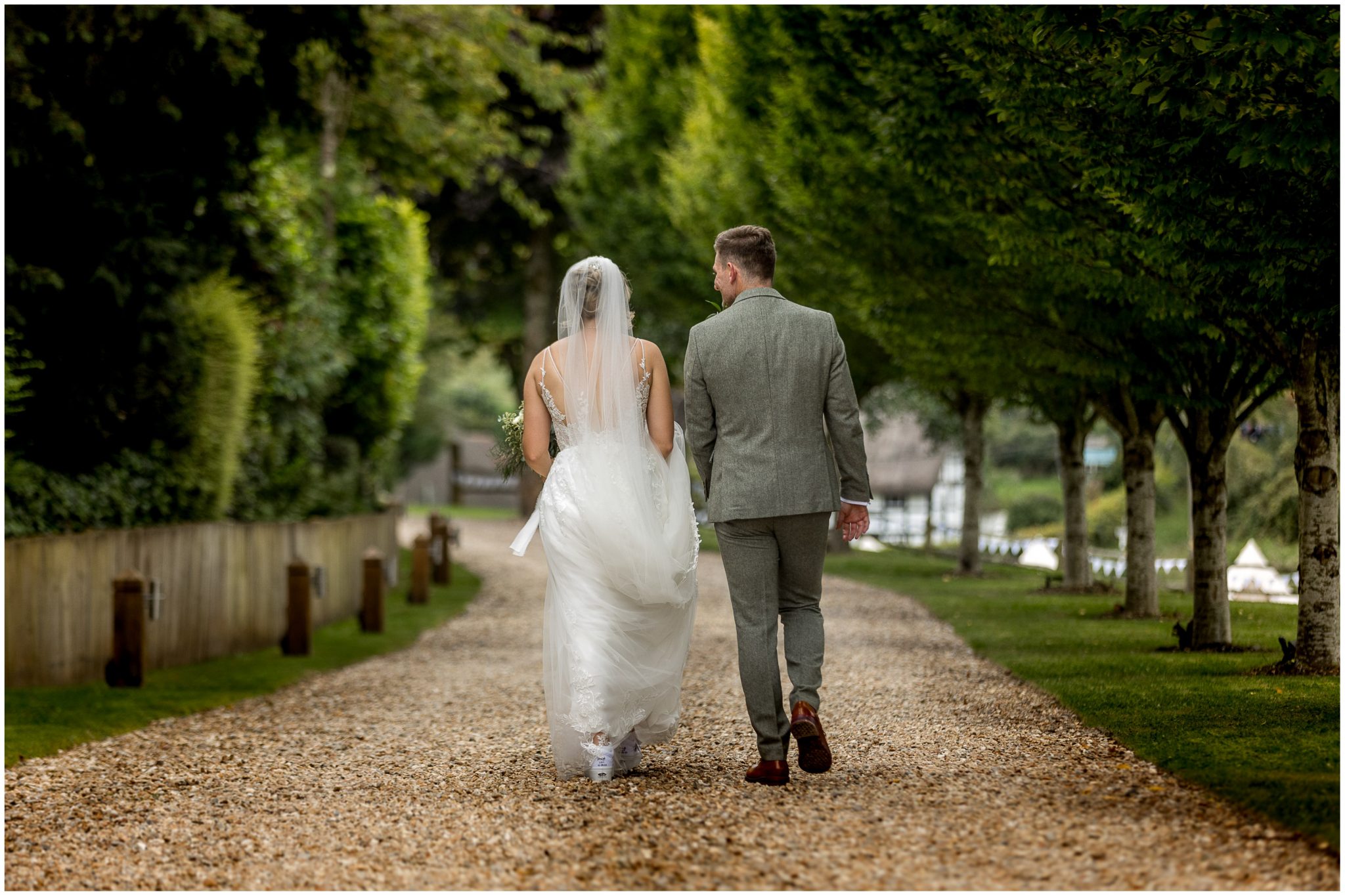 The bride and groom walk towards their wedding reception