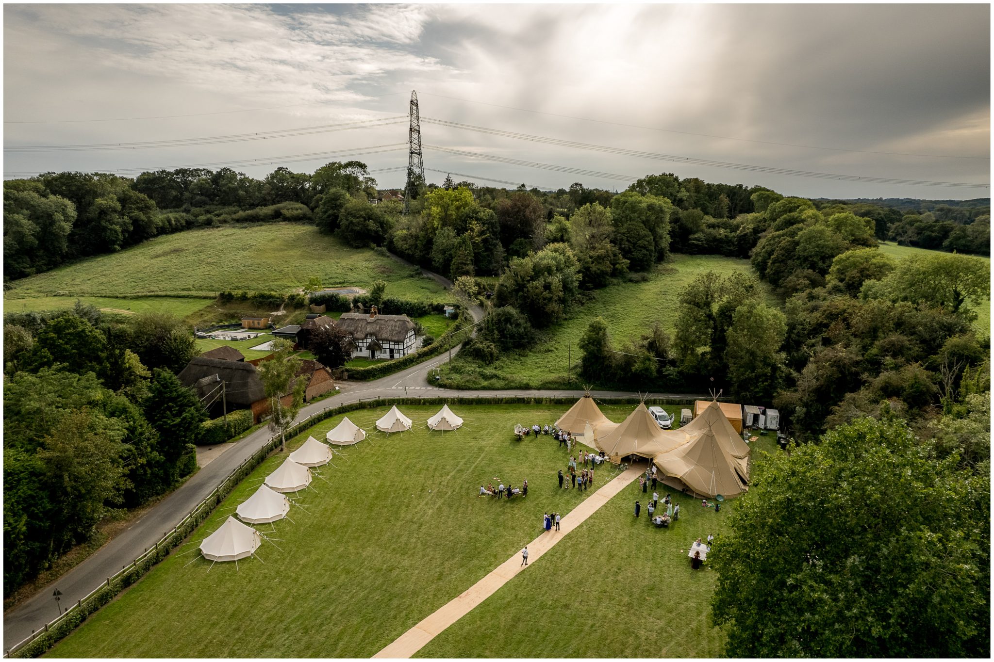Drone image of the wedding reception with tipi marquee and lamping pod bell tents