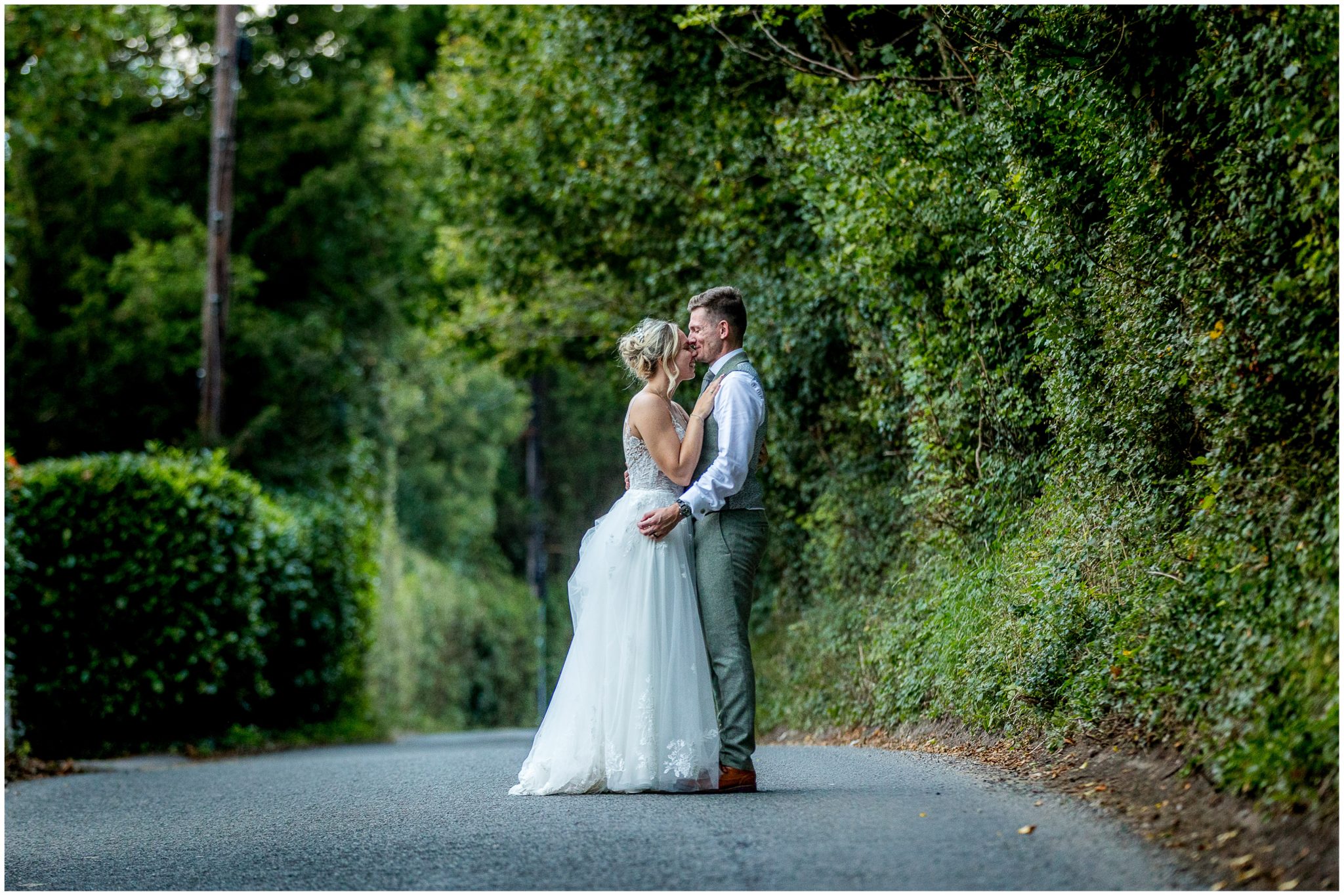 The wedding couple share a moment on a quiet country lane