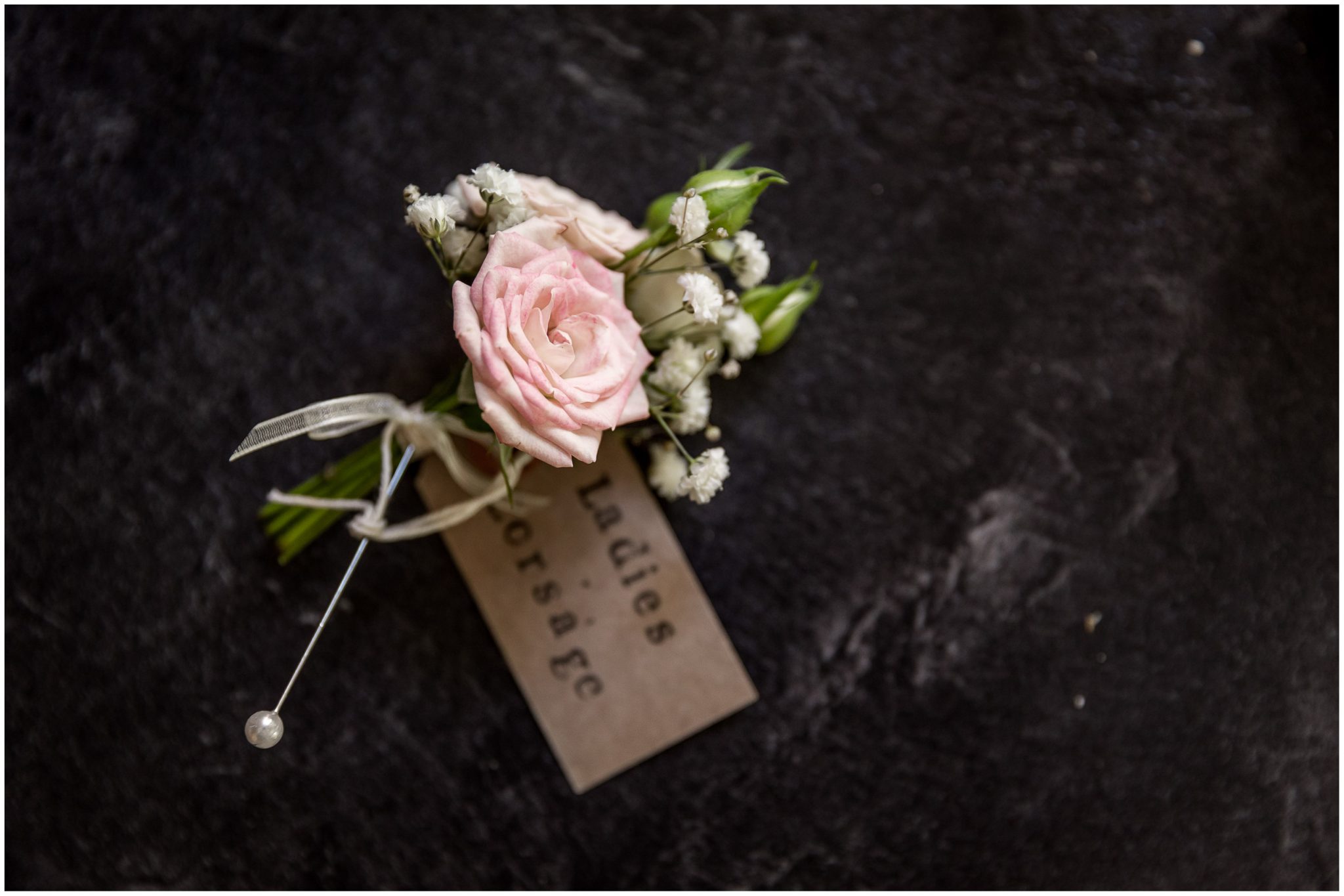 Floral detail of buttonhole for wedding outfit