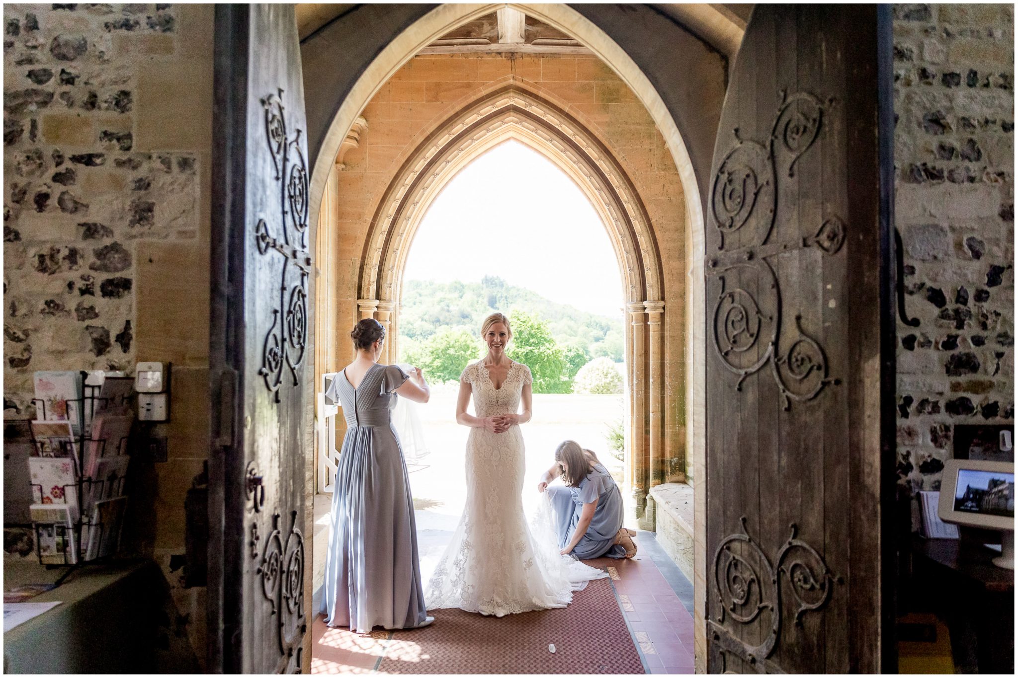 The bride stands in the doorway to the church, ready to walk down the aisle