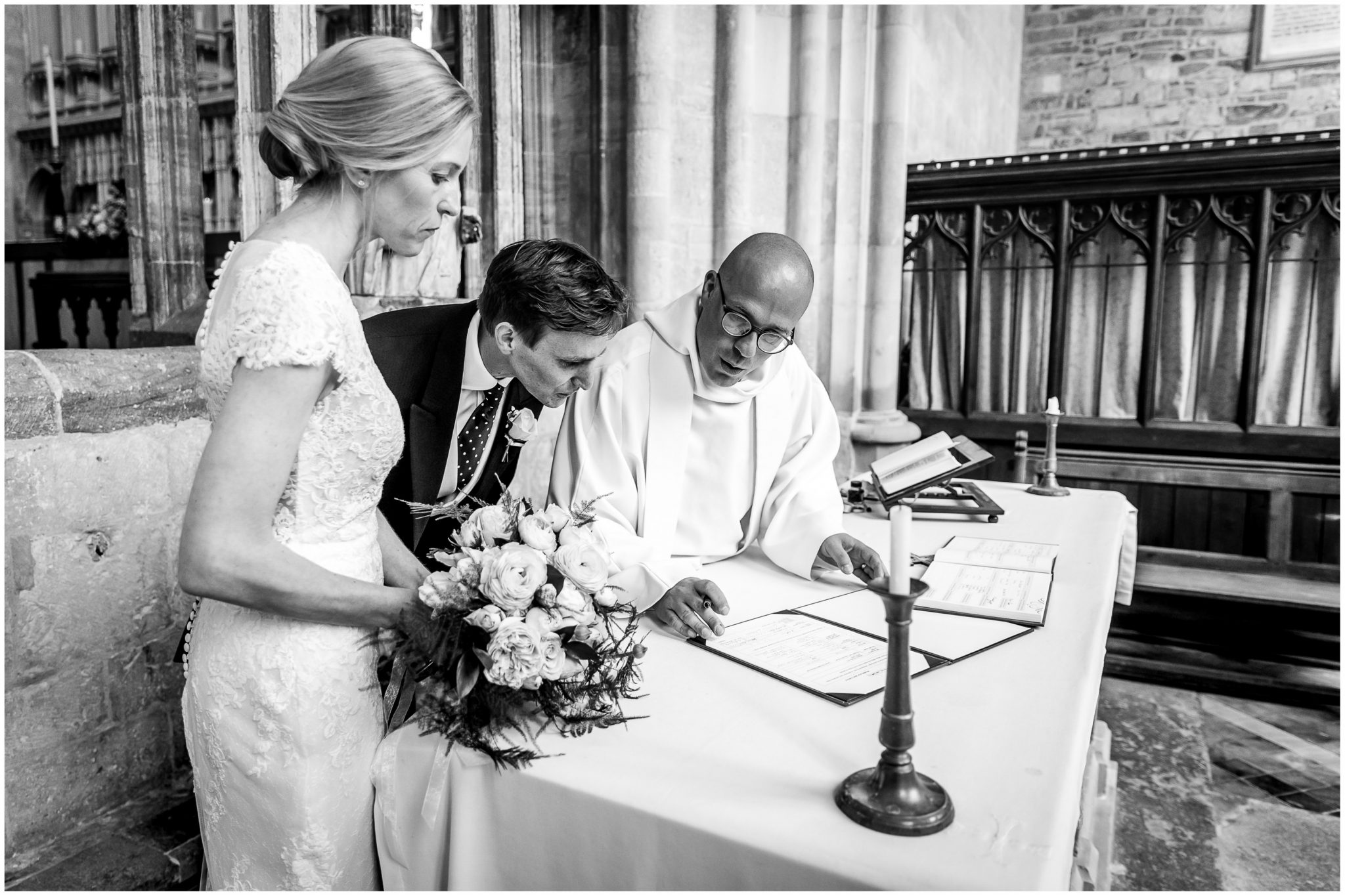 Bride and groom documentary photograph during the signing of the marriage register