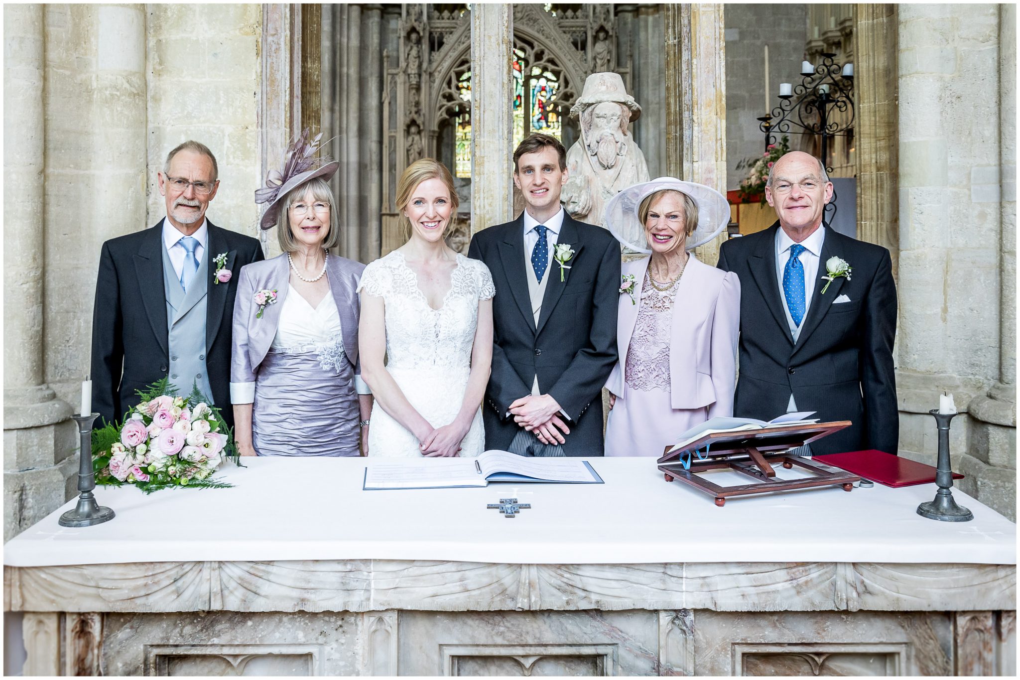Bride and groom with family at the signing of the marriage register