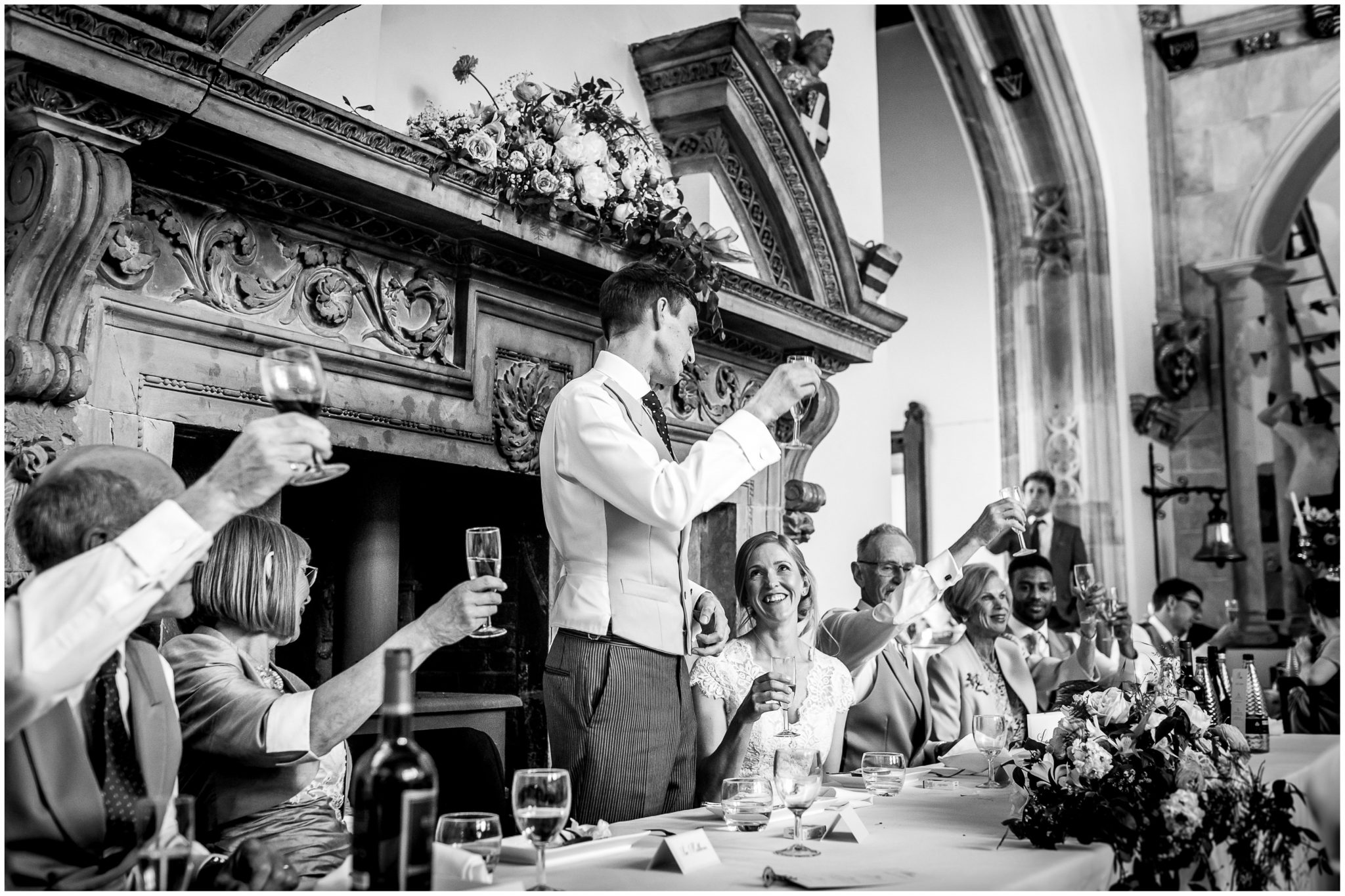 The groom raises a glass for a toast during his wedding speech