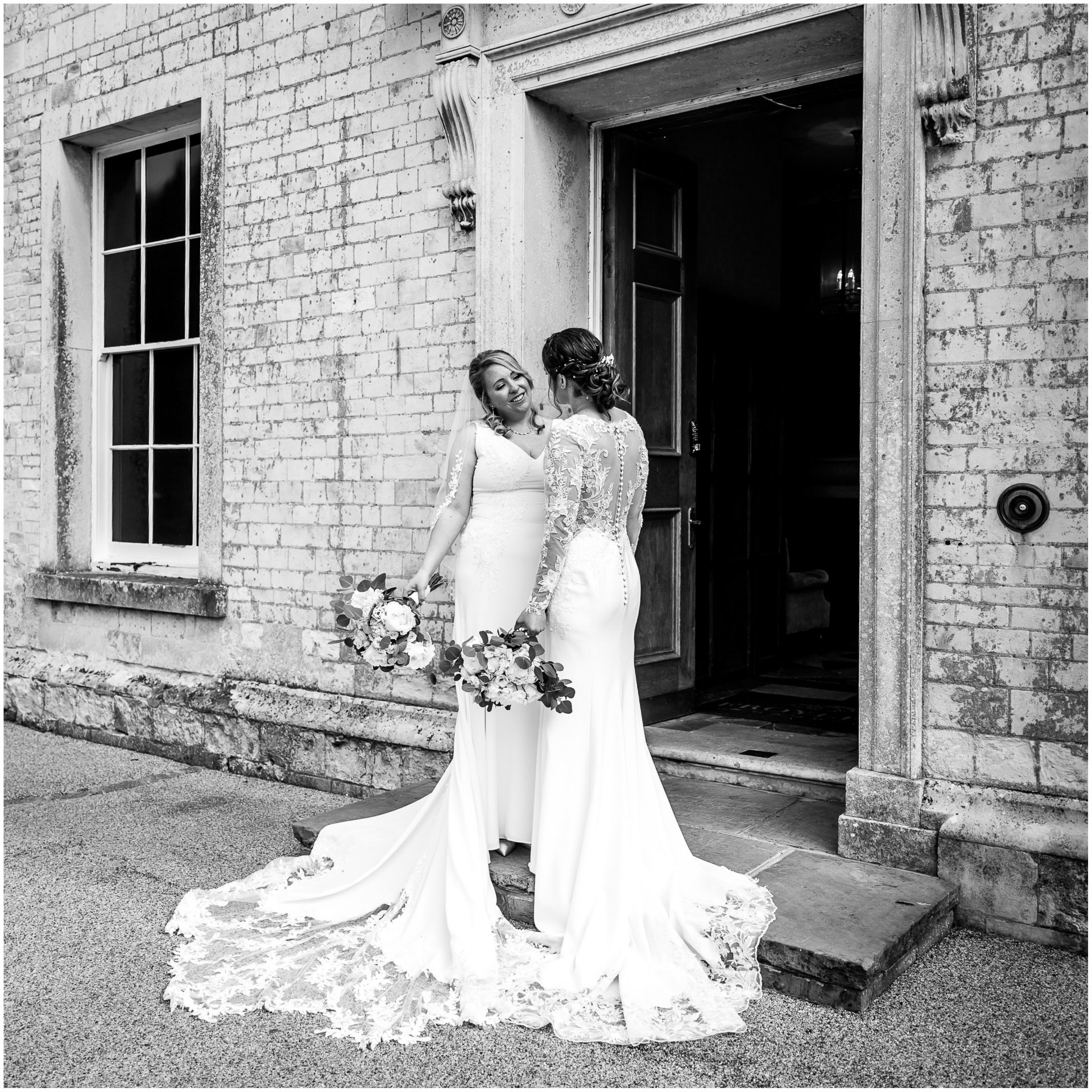 Bride and bride black and white portrait by front entrance of Hampshire wedding venue