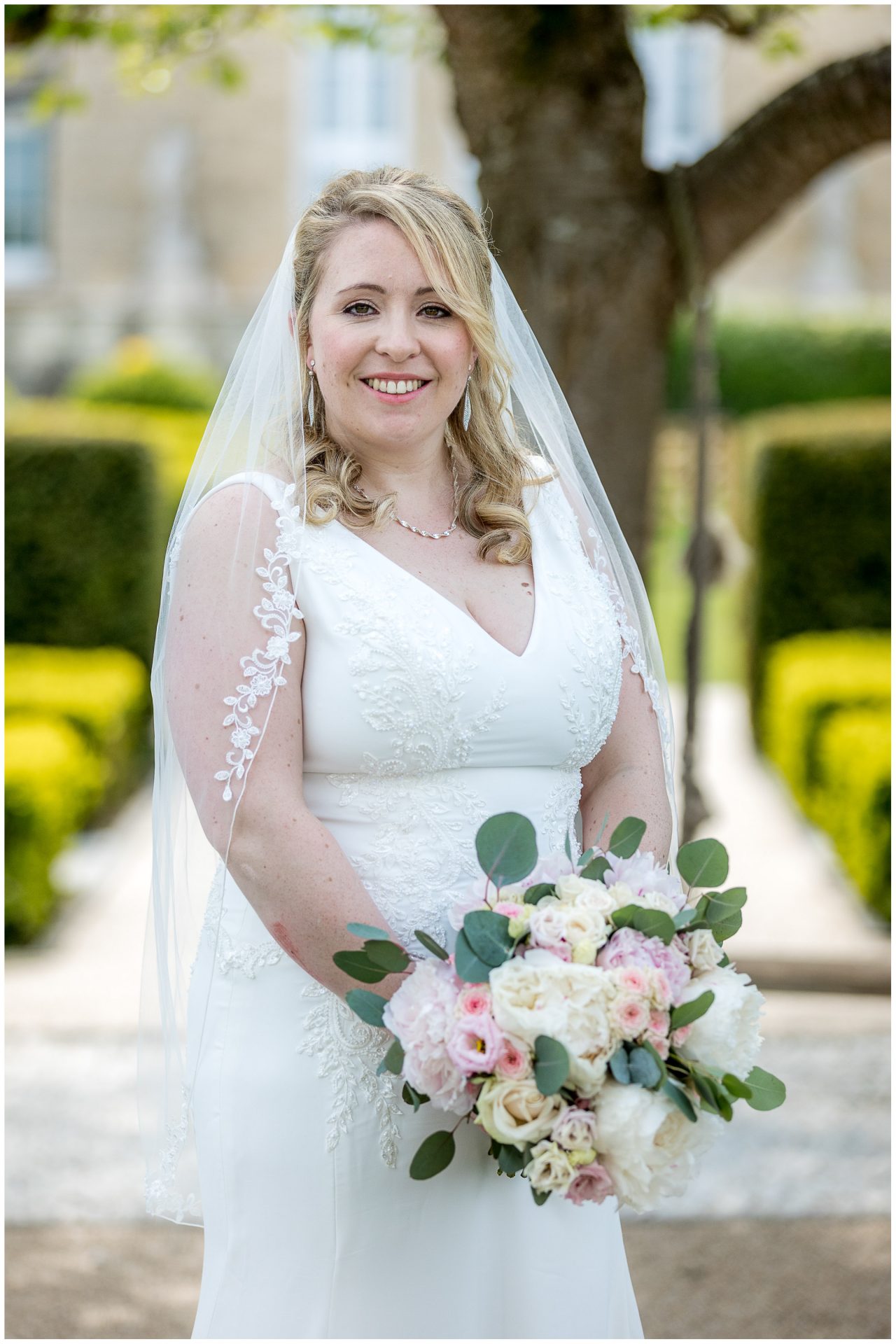 Colour portrait of bride in gardens of Hampshire wedding venue at Froyle Park