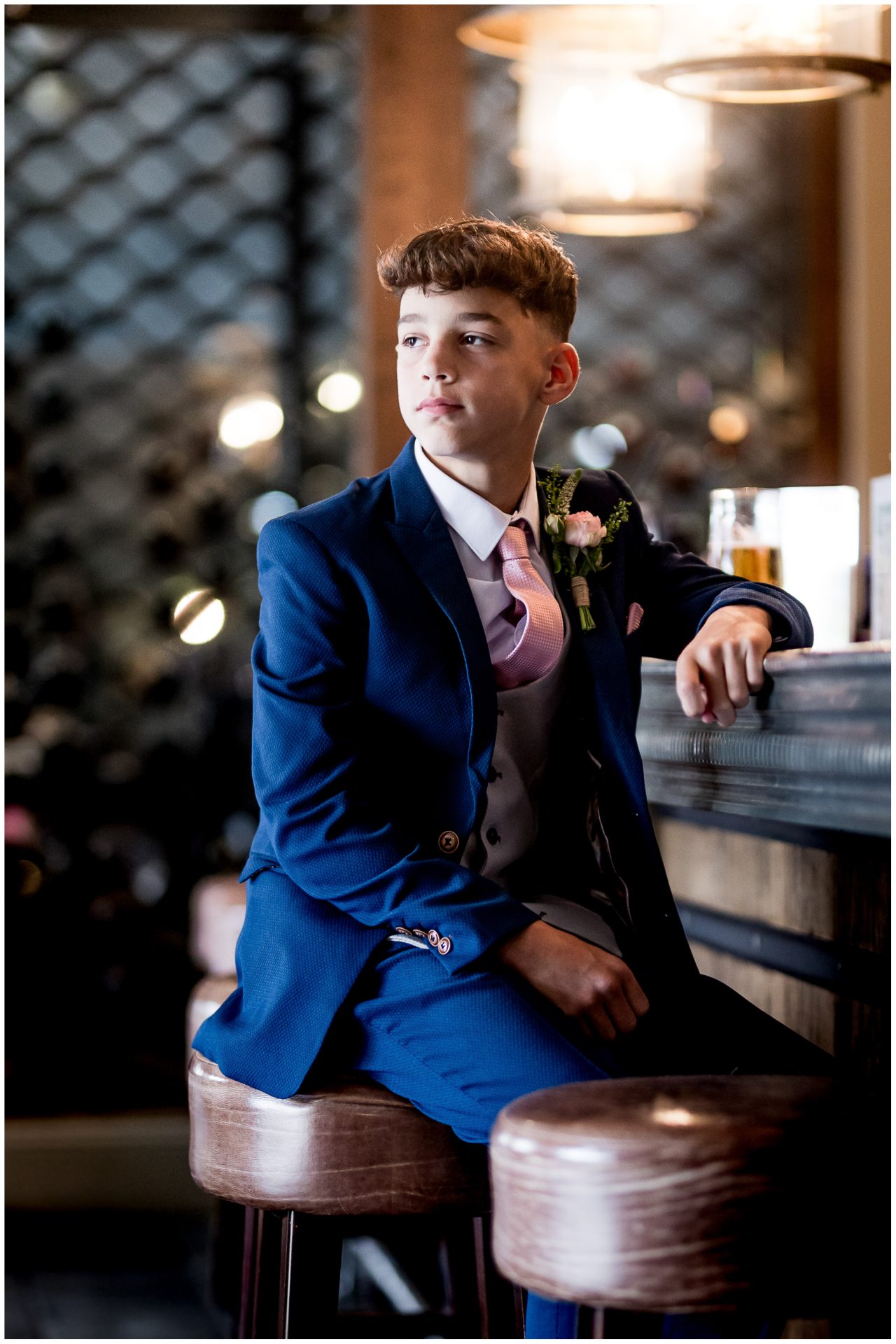 Portrait of the groom's son at the hotel bar