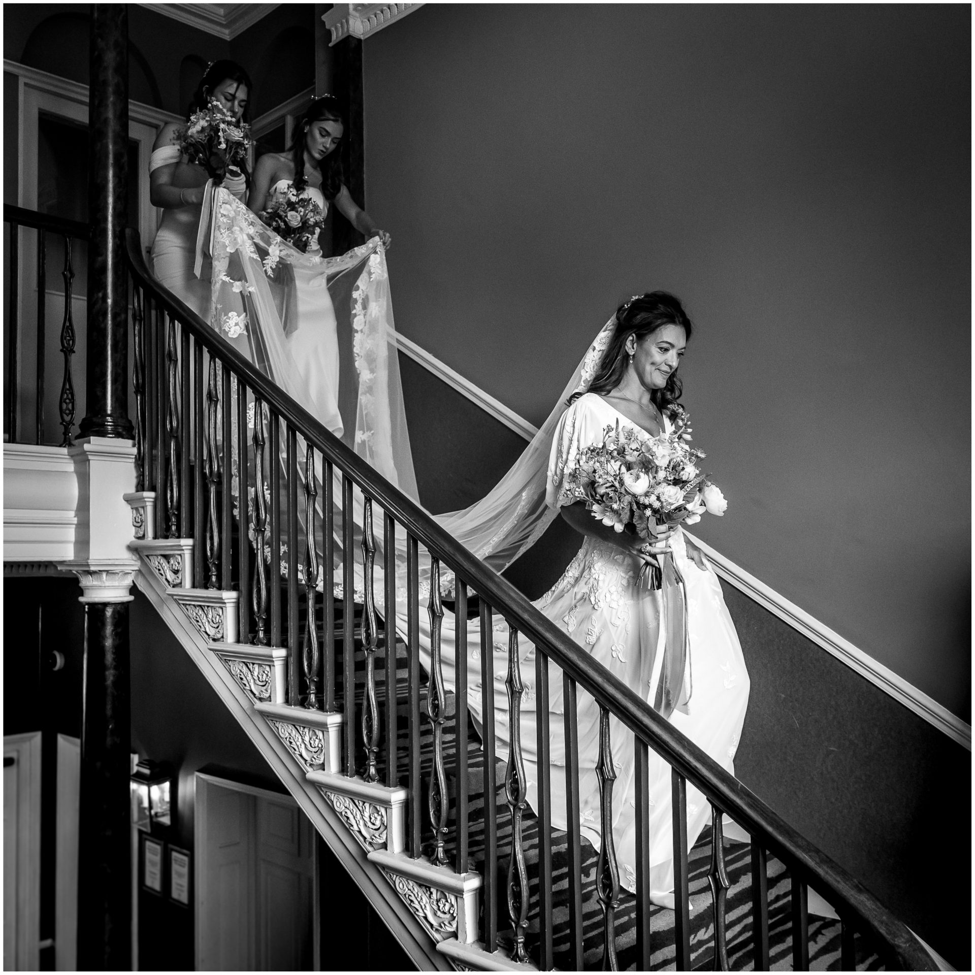 The bride walks down the staircase of the Hotel du Vin in Poole to the ceremony room