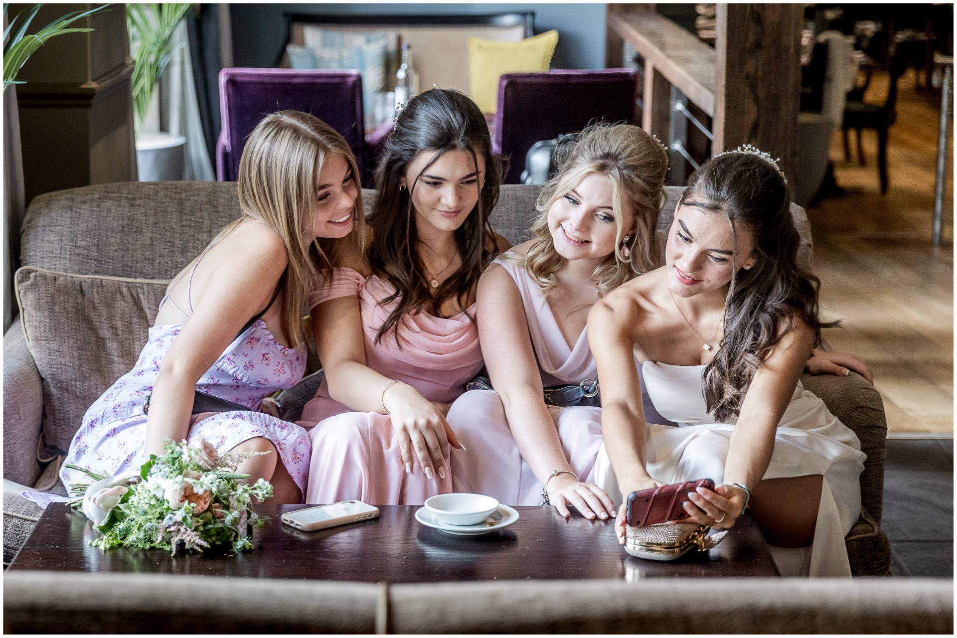 Bridesmaids take a selfie in the bar during the drinks reception