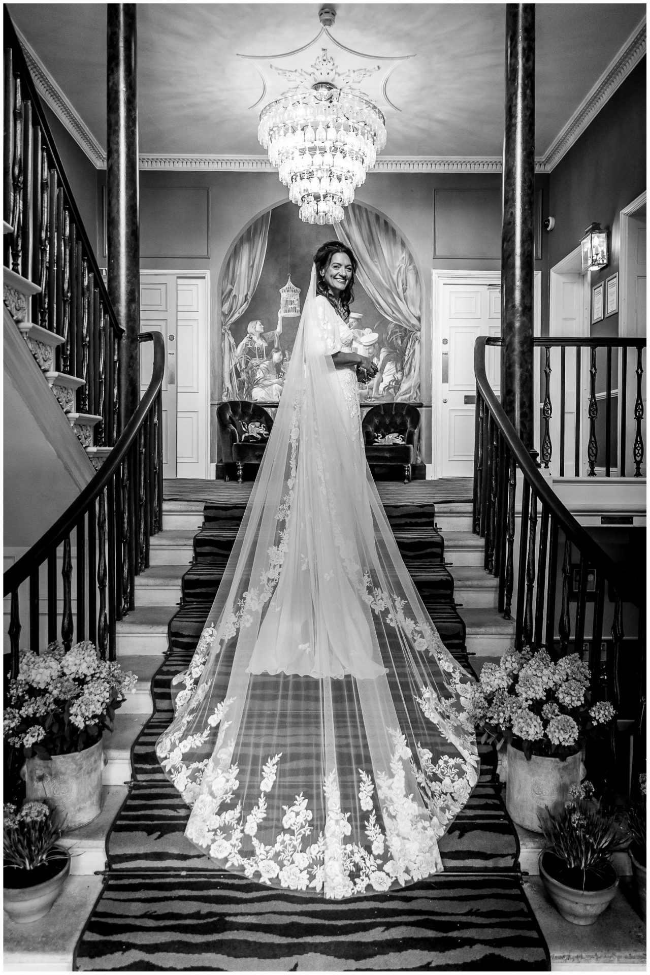 The bride displays her wedding dress and veil on the grand staircase in the lobby of the Poole Hotel du Vin